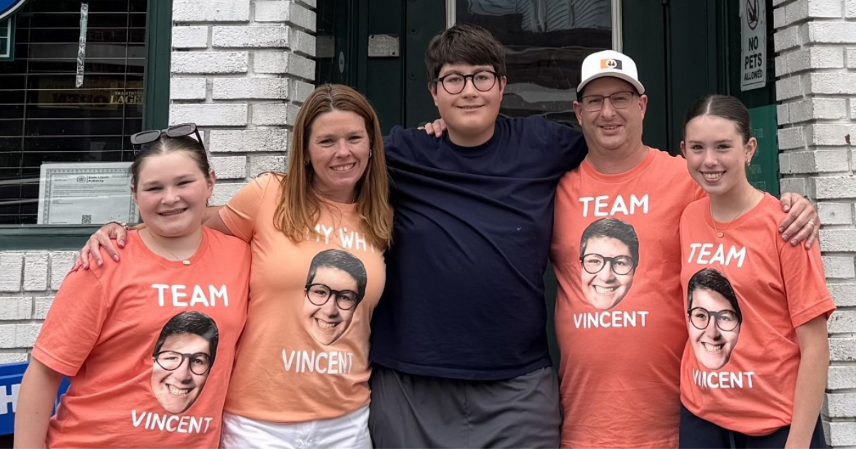 Family of five wearing matching Team Vincent shirts at a fundraising event.