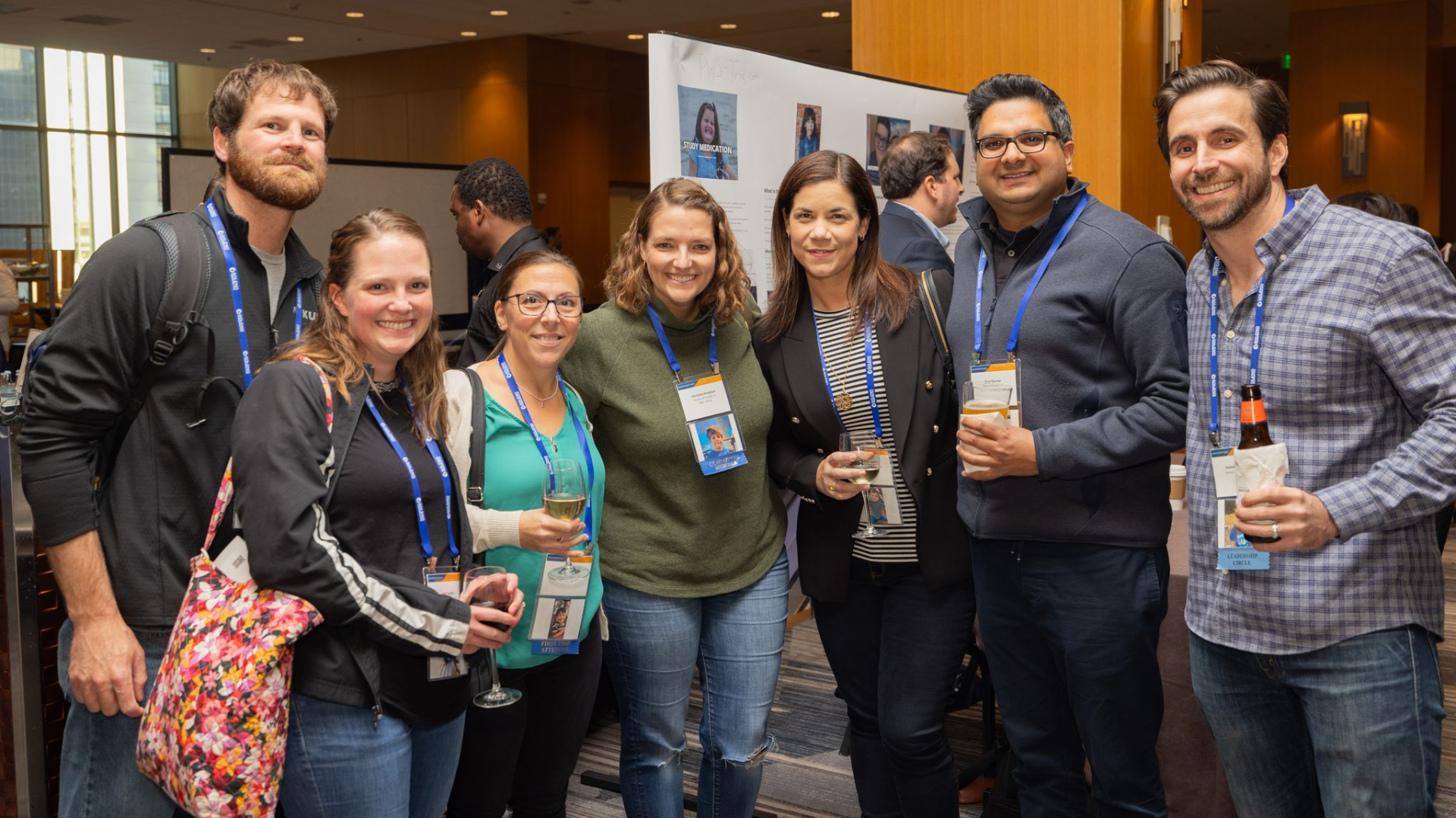 Group of FPWR conference attendees smiling together during a reception.